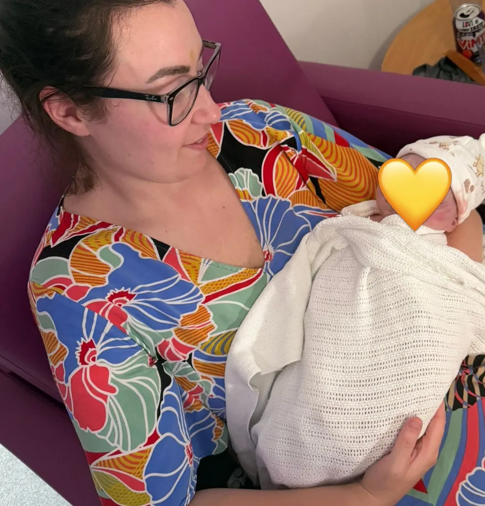 Nicola cradling a newborn
